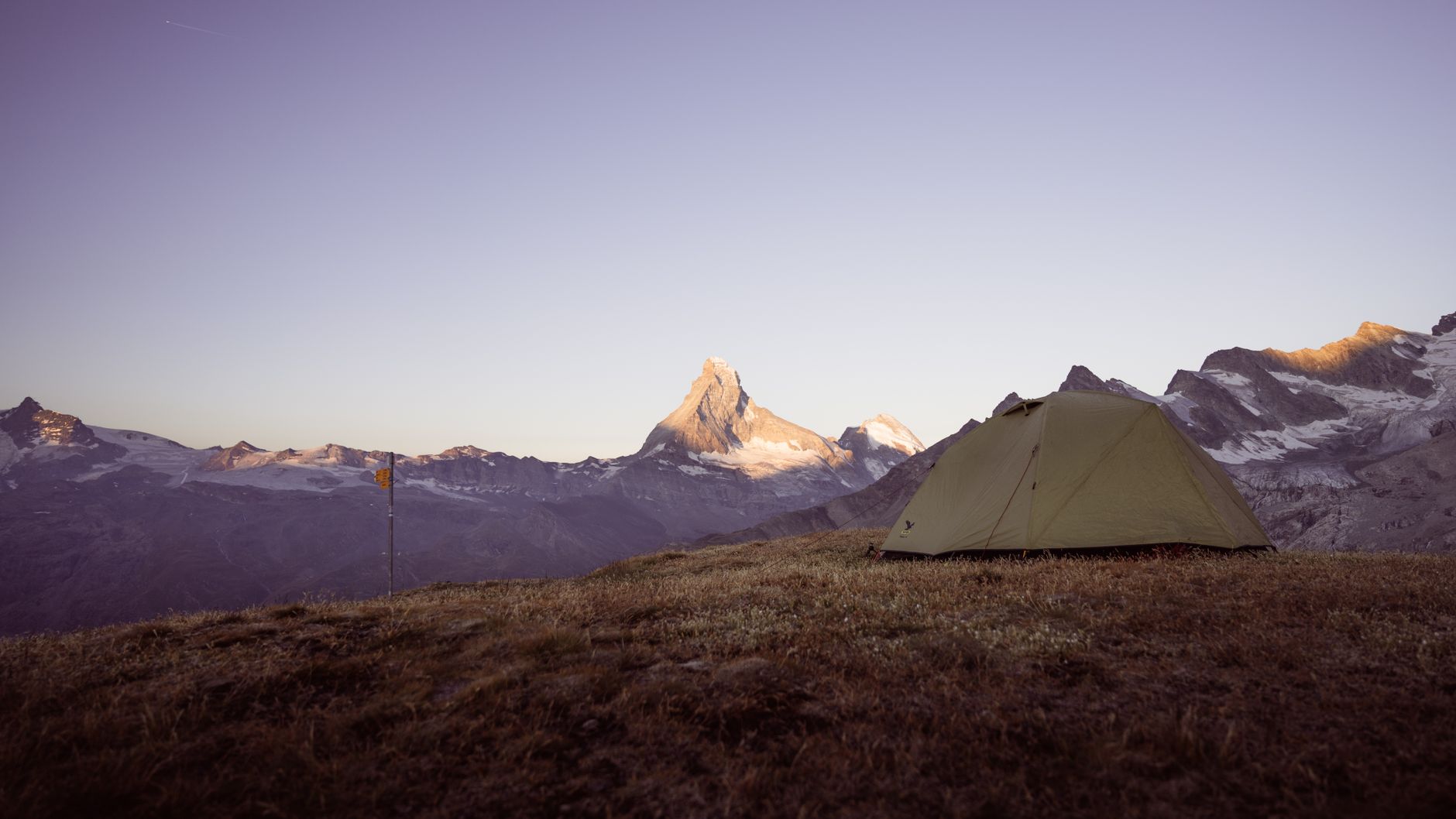 Expedition tent overlooking high altitude alpine valley