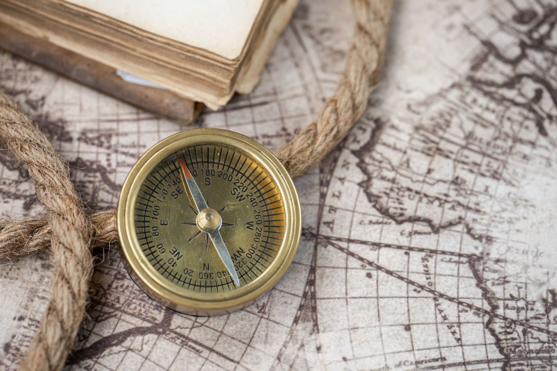Traveler looking over vintage maps and nautical compass